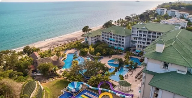 Aerial view of resort buildings, pools and the beach at Bijao